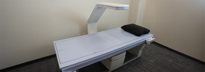 Chiropractic San Antonio TX DXA Table A white medical table with an angled arm above the table